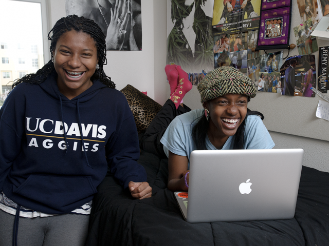 two girls in a dorm room 