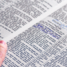 hand resting on a dictionary page