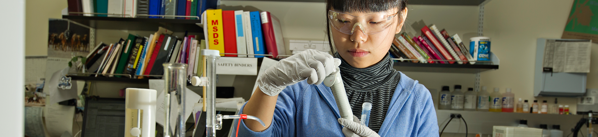 girl working with a test tube in a lab 