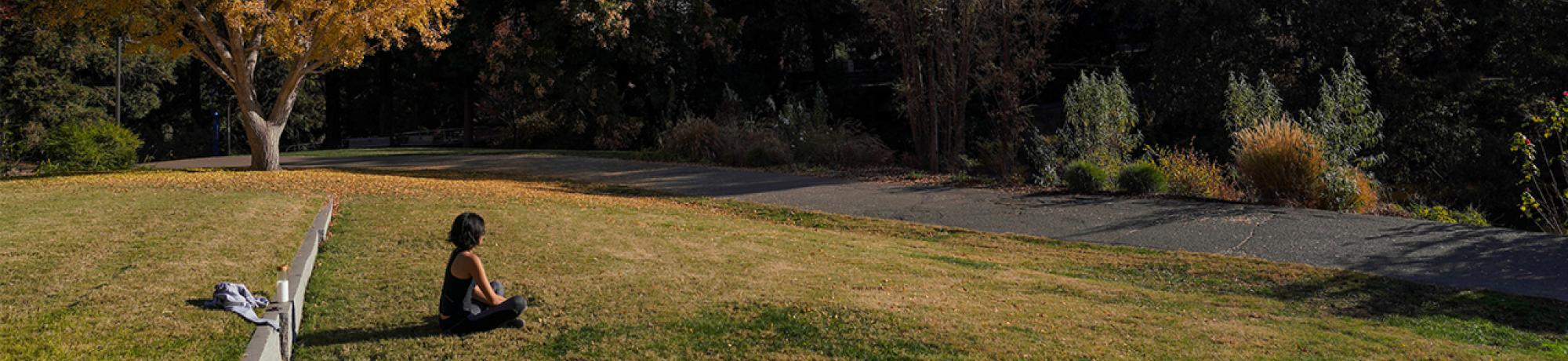 Woman meditates in Arboretum