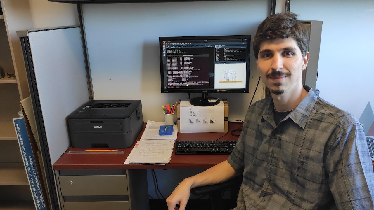International Scholar Alex Zanella Zaccaron in his office at Hutchison Hall in Mar. 2020 Alex Zanella Zaccaron sitting at desk