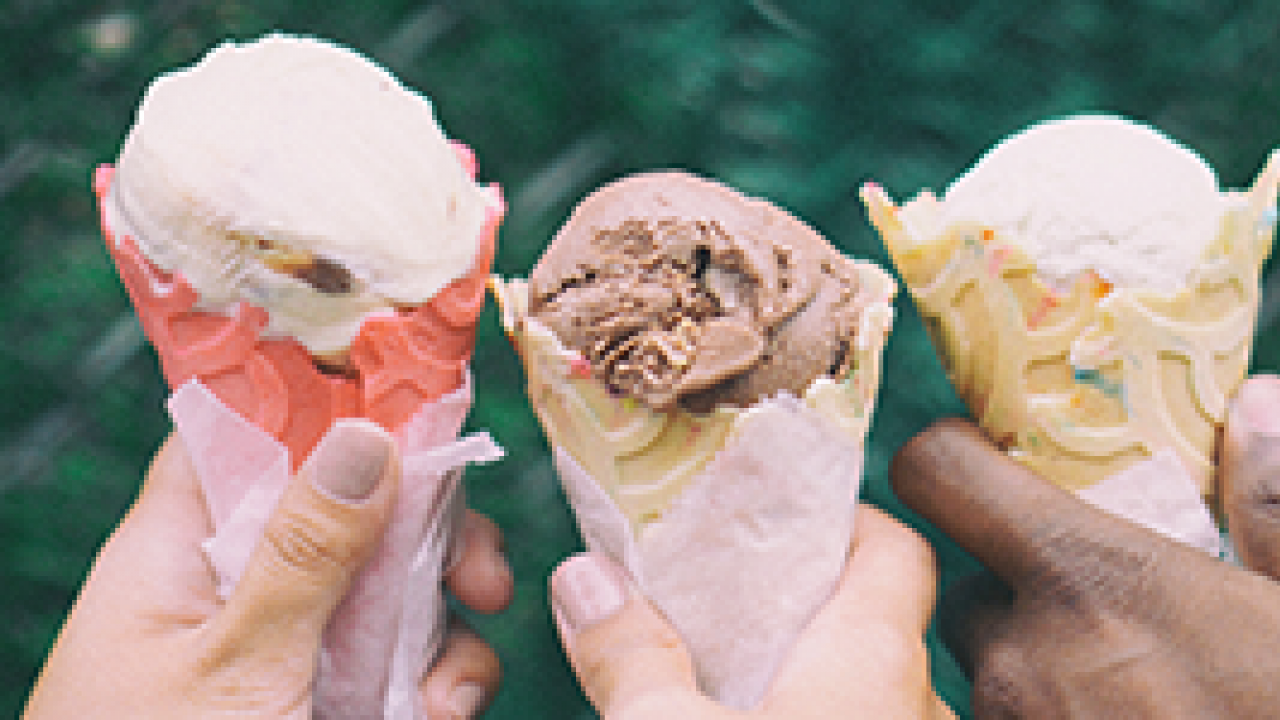 hands holding ice cream cones