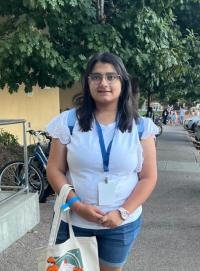 Photo of Riya Kotak outside in the shade.