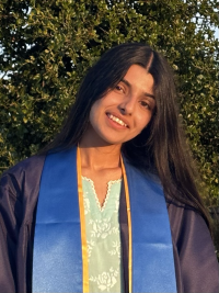 Photo of Geeta Sharma wearing graduation regalia.