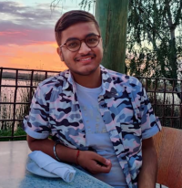 Photo of Sameer Sharma with a sunset in the background.