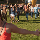 girl running and high-fiving students 