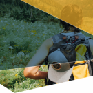 woman backpacking with color splotches