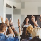 group of people with their hands raised 