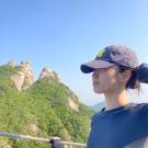 Profile of Eunice Choi outside wearing a baseball cap.