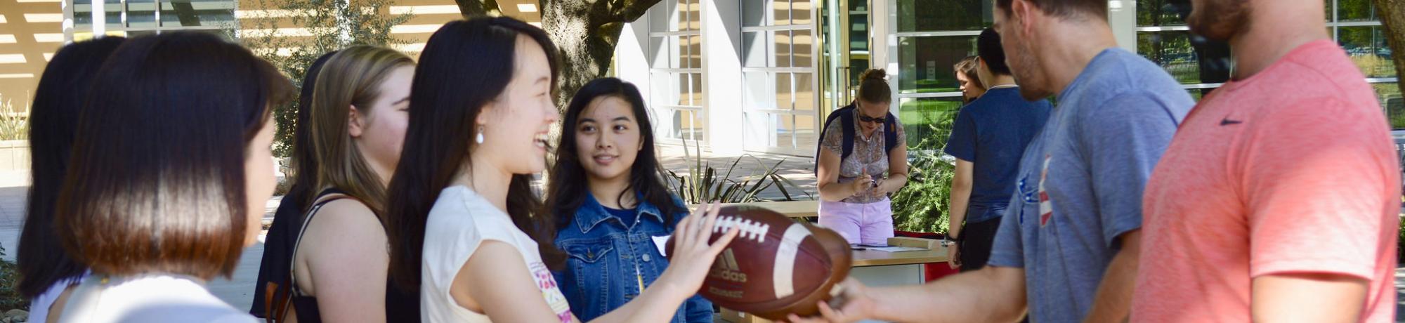 students holding a football