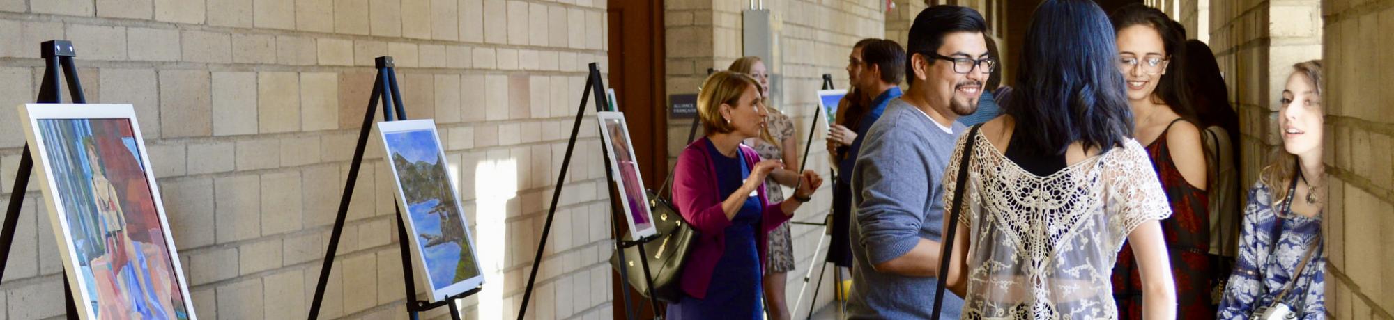 Students, scholars, and faculty in art exhibit