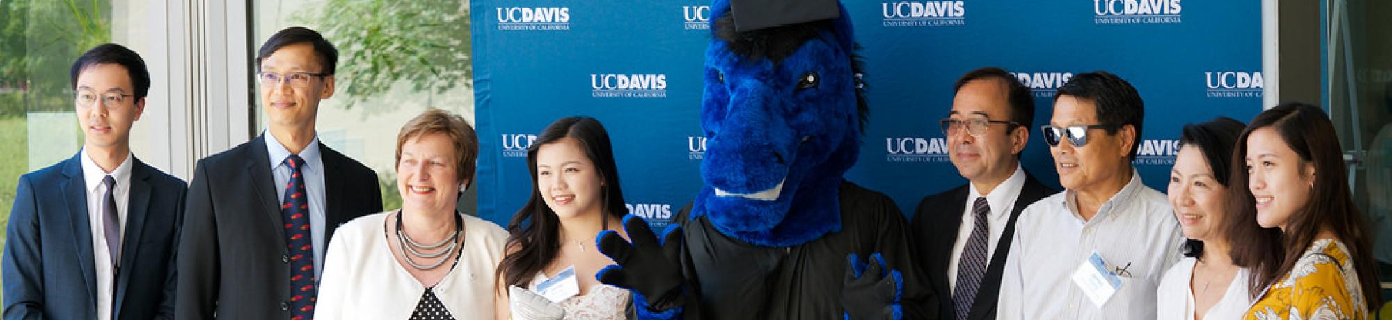 International Student graduation with Gunrock the Mustang