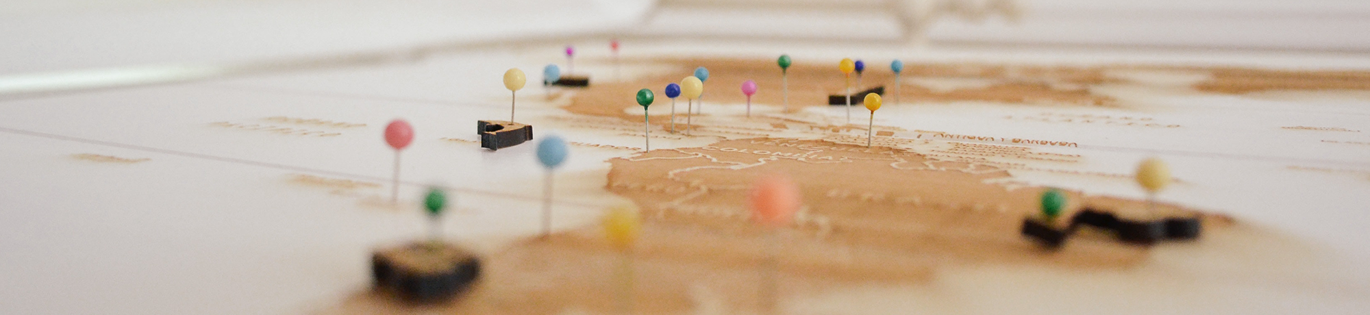 push pins in different colors on a map