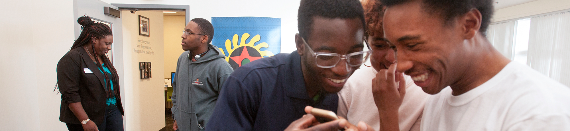 boys looking at a phone smiling 