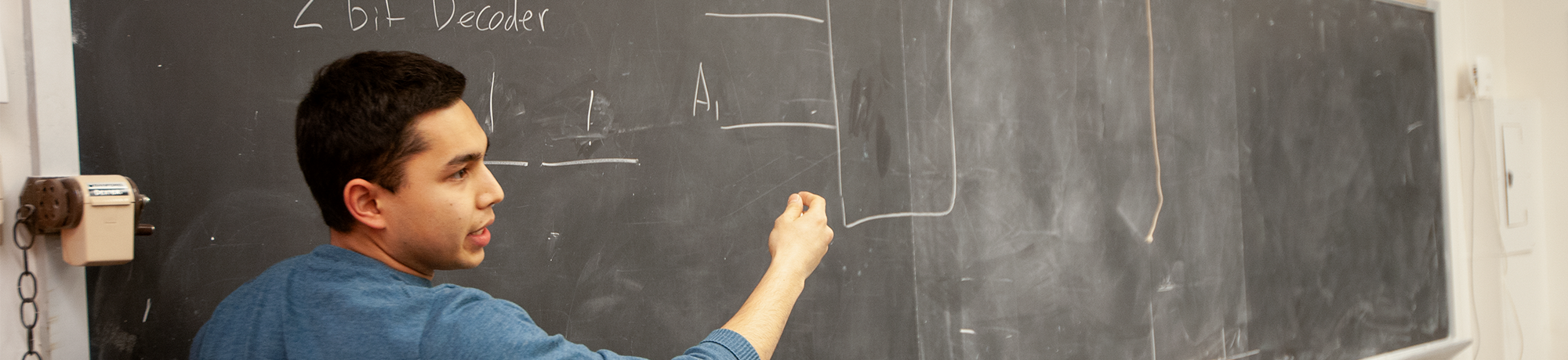 man standing at a chalkboard
