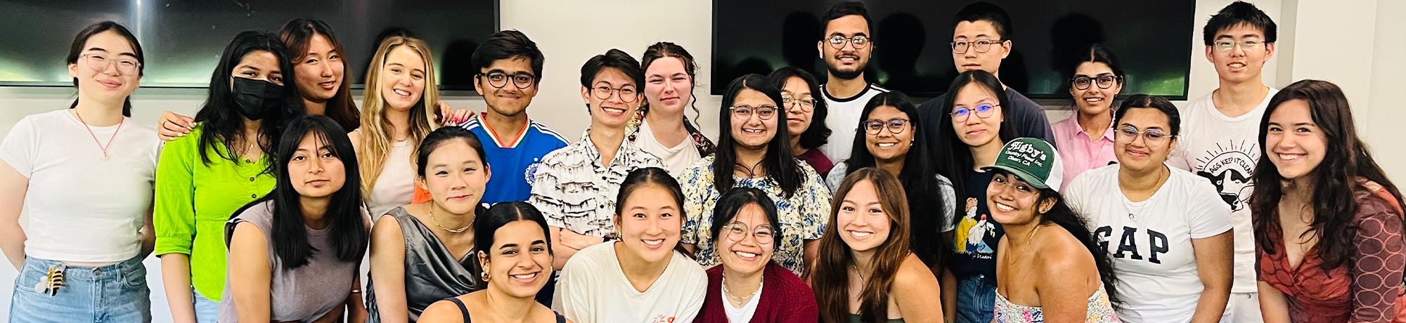 A group photo of 24 smiling student mentors.