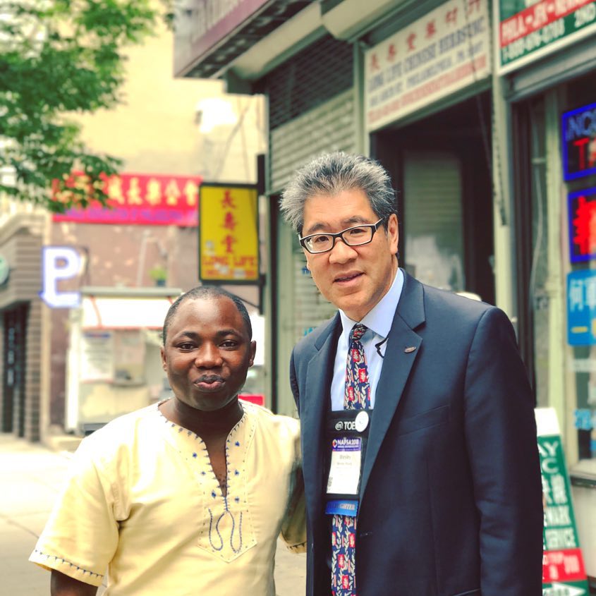 two men standing together smiling