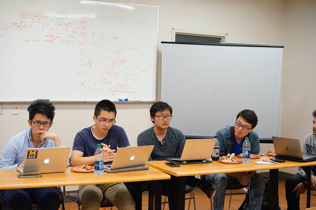 group of students at a share desk programming